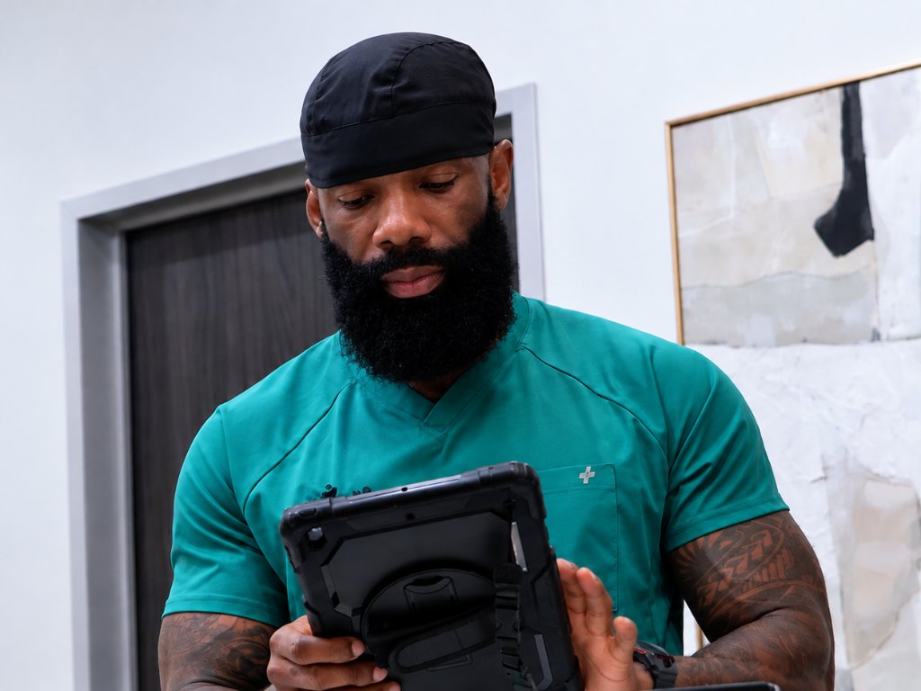 Dr. David Nwokeabia reviewing clinical information on a tablet